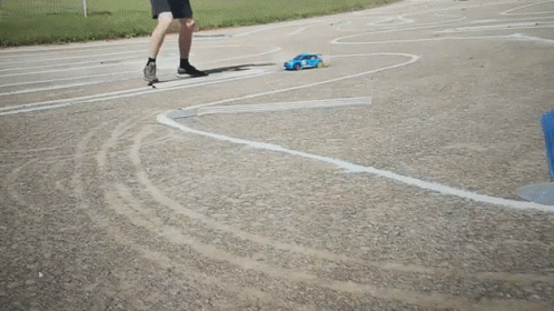 a man on a paved track riding an skateboard