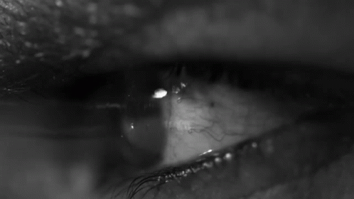 a close up image of an eye with tears