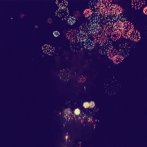 a very bright fireworks show is lit up the night sky