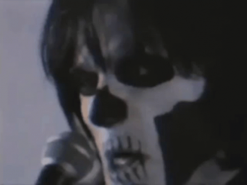 a skull with dark eyes, a face paint and no hands