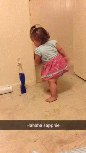 there is a little girl standing in the bathroom