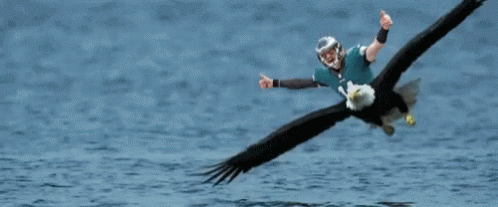 an eagle is flying with a man dressed in suit