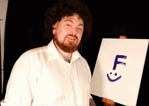a man wearing a white shirt holding a sign with a five symbol on it