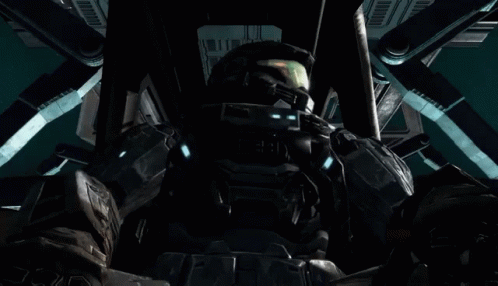 a halo spartan standing in front of a giant robot