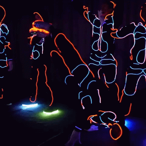 people using neon lights in the dark while doing different dance