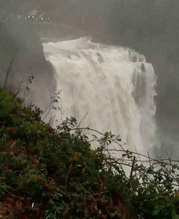 the large waterfall has water pouring over it