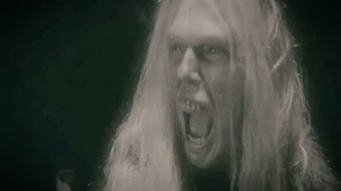 an image of a man with long hair screaming in black and white