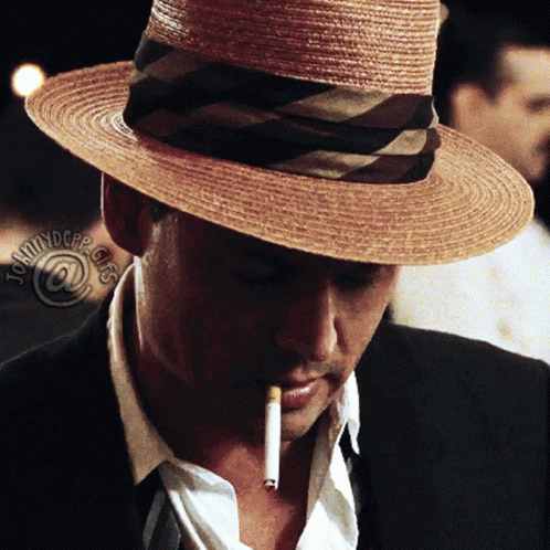 a man with a blue hat and cigarette