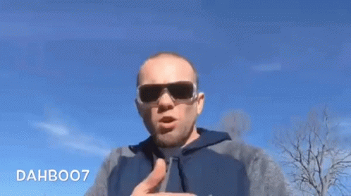 a man pointing a finger and wearing sunglasses