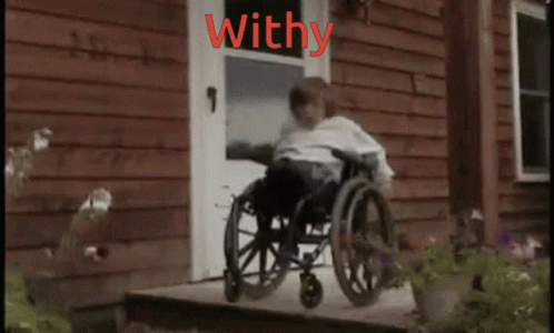 an old pograph of a boy sitting in a wheelchair outside