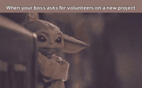 baby yoda peeking up over a wall with a caption that says, when your boss asks for volunteers on a new project