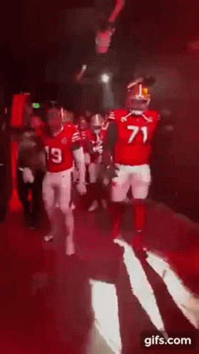 an image of the football players being escorted out of tunnel