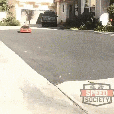 a car is parked on the sidewalk in front of houses