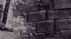 a close up of a brick wall with bricks around it