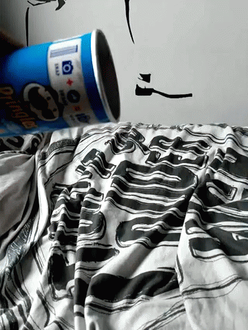 a person pouring a can into the bed