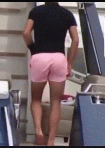 man walking up stairs wearing shorts in store