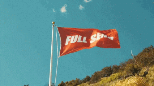 a blue flag is being flown on top of a hill