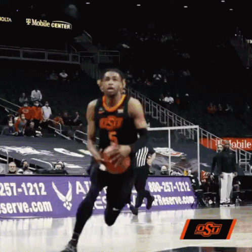a man with a basketball running down a court