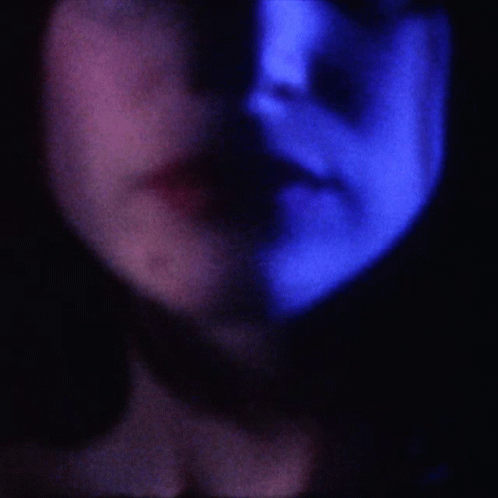 a blurry po of a person's face in the dark