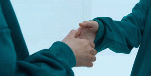 two people in blue gloves holding hands with a white background