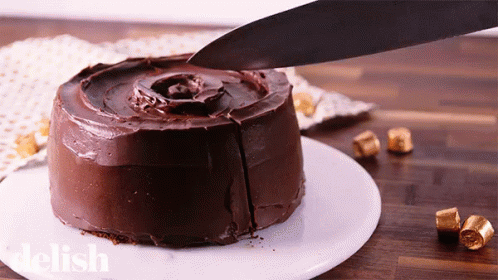 a chocolate frosted cake with a knife  into it