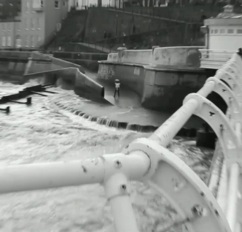black and white image of water spraying from boat