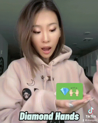 a woman holding her cell phone and a diamond on it