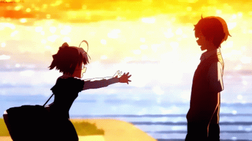 two silhouettes of two people on a beach, one is holding soing in the other hand