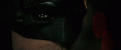a man in the dark wearing a black mask