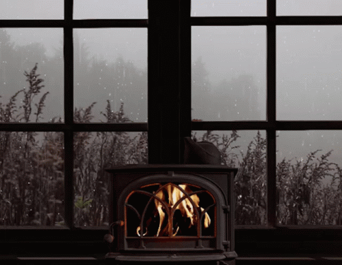 a dark window with a blue stove near it