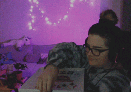 a girl holding up a book in a room