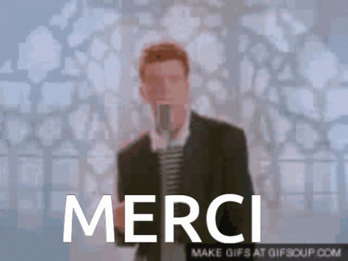 a man in suit with blue background that reads merci