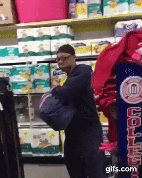 a man wearing a blue mask is standing in front of the shelf in a grocery store