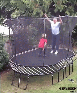 a couple of men standing on a trampoline