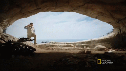 the man is standing in an ocean cave