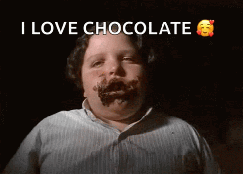 a child with cake on his face with chocolate words