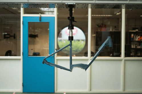 a metal swing suspended in a classroom with no door
