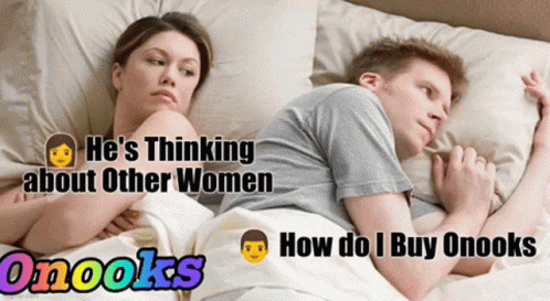 two people laying in bed looking at each other