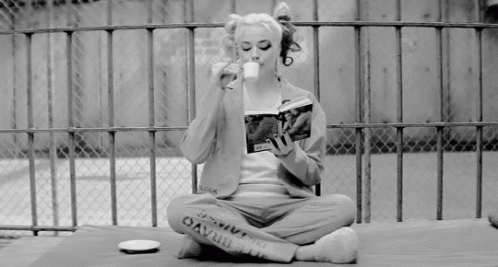 woman in a prison with a coffee mug and magazine