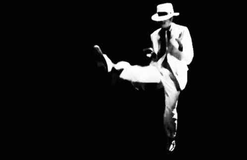 a person in white suits and hat kicks a leg in black