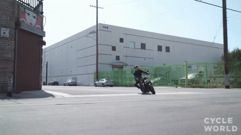 a person on a motorcycle outside of a building