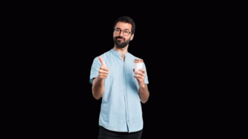 man holding up two thumbs in front of his face