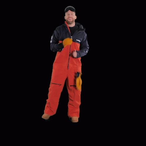 a man in snow gear standing outside in the night