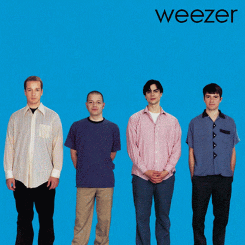 the members of weezer standing in front of a yellow background