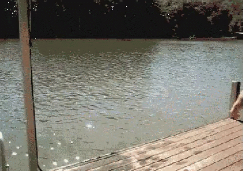 a picture of the dock with an umbrella and the water
