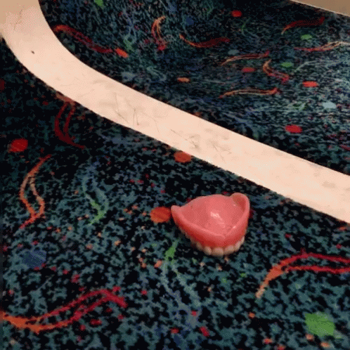 a plastic toy heart sitting on the ground