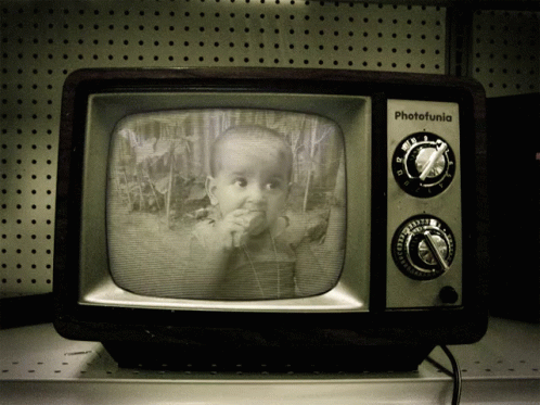 a black and white television that is on a shelf