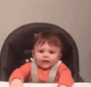 a baby sitting in a seat of a baby bouncer