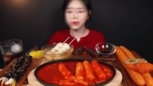 a woman sitting in front of an image of food