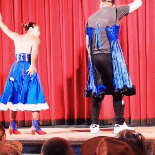 two people wearing costumes that are on a stage